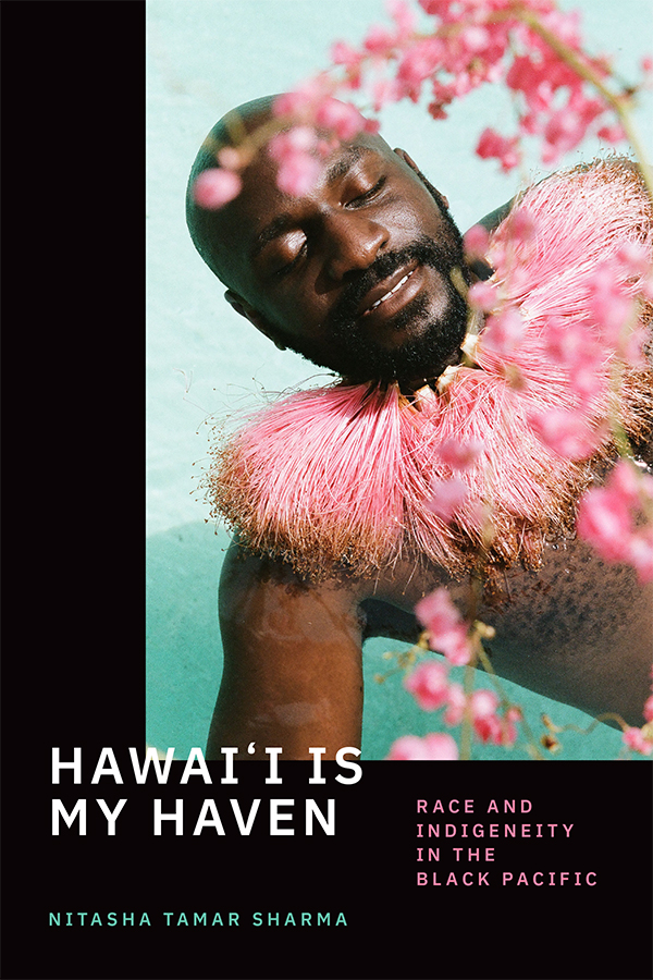 Cover of Hawai′i Is My Haven: Race and Indigeneity in the Black Pacific by Nitasha Tamar Sharma. Features a photograph of singer Kamakakēhau by Kenna Reed. Photo is of a bearded Black man in a large pink shaggy collar with pink flowers around him.